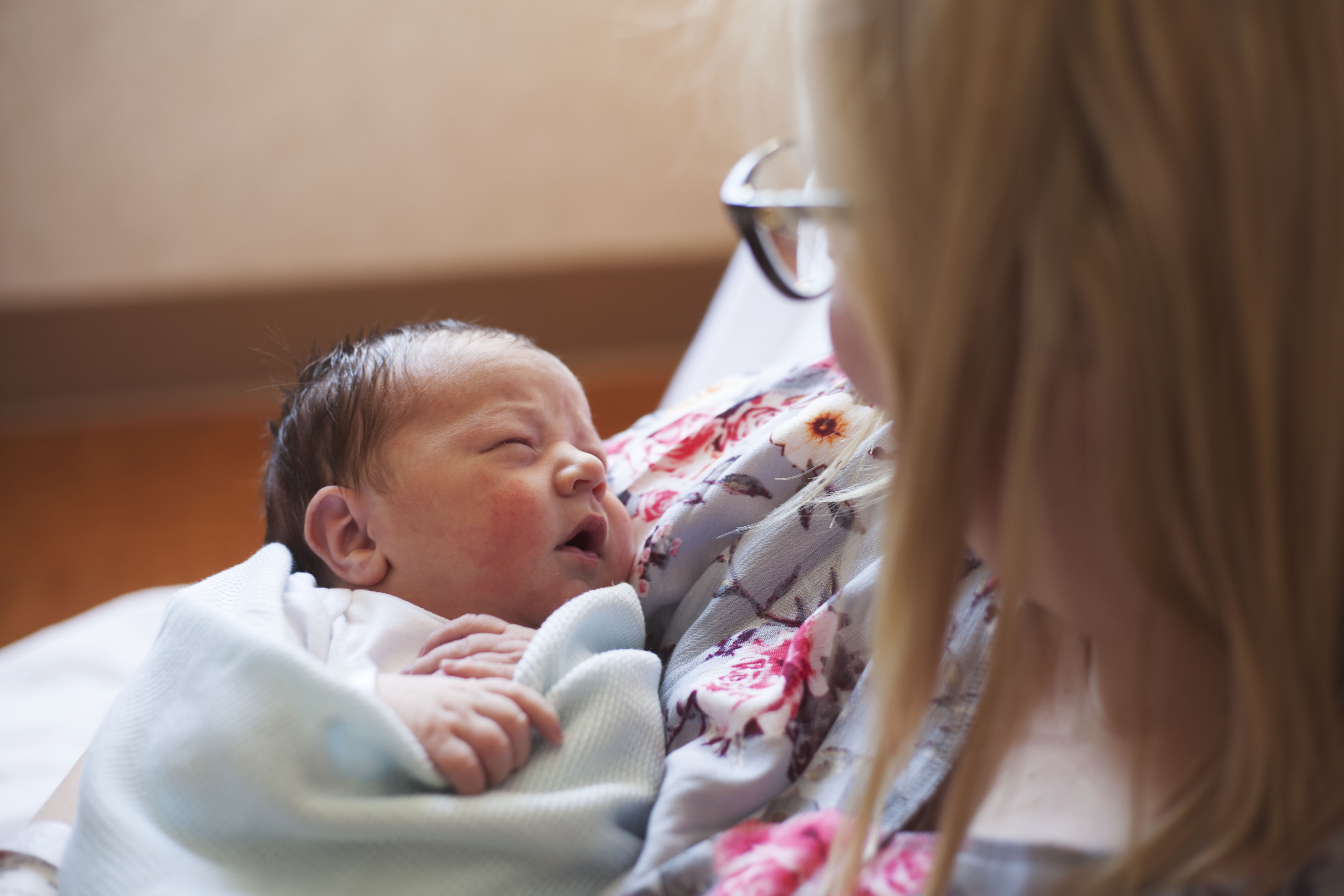 A mother holds a newborn baby