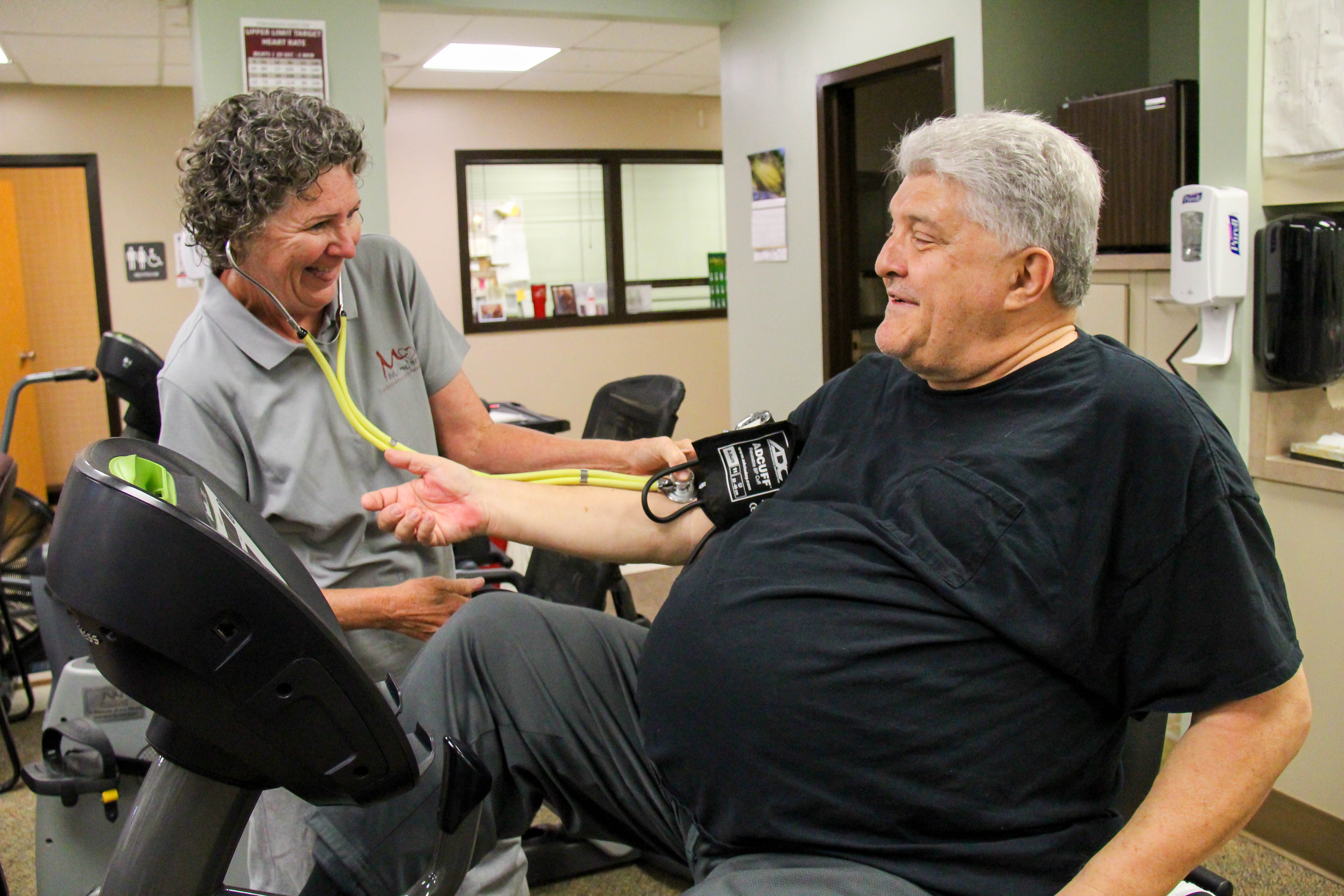 Nurse takes blood pressure while patient is exercising