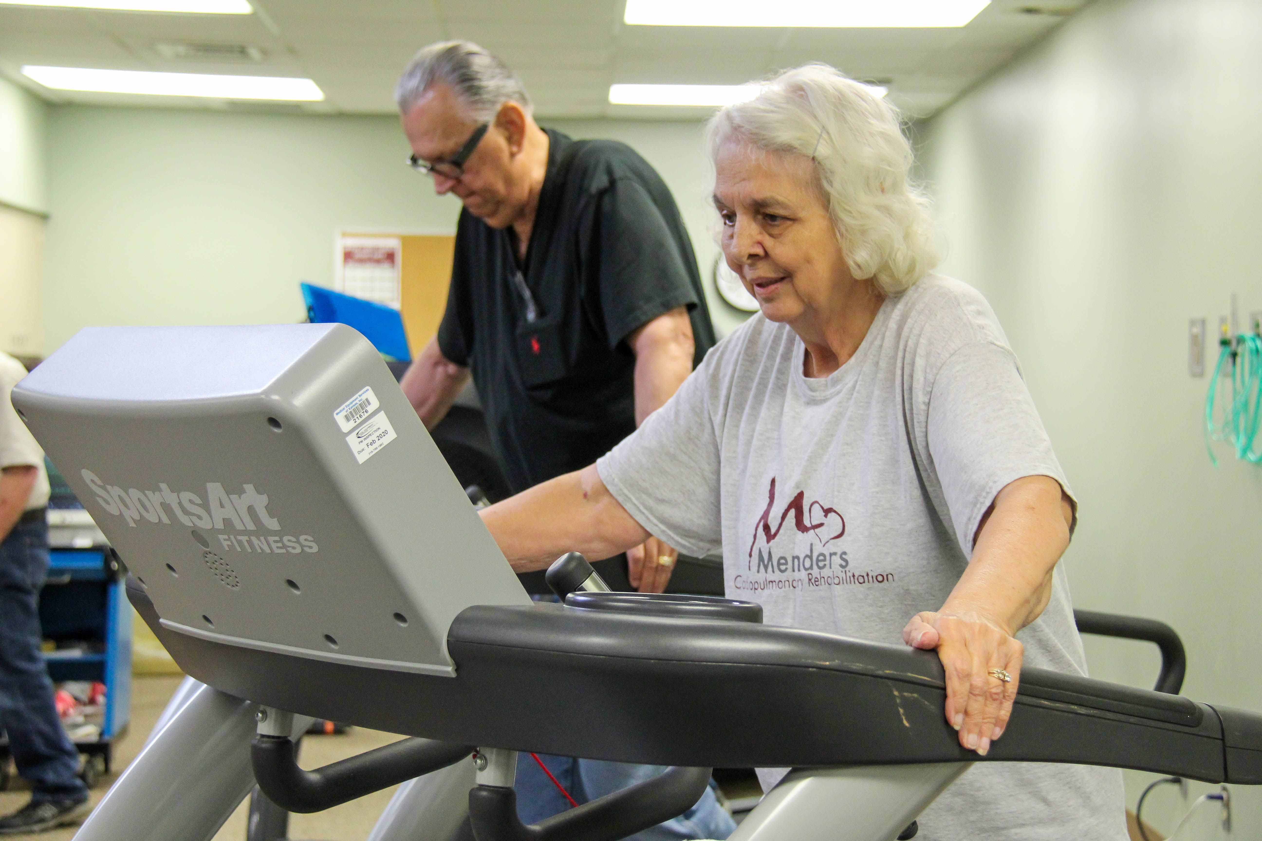 Two people on treadmills