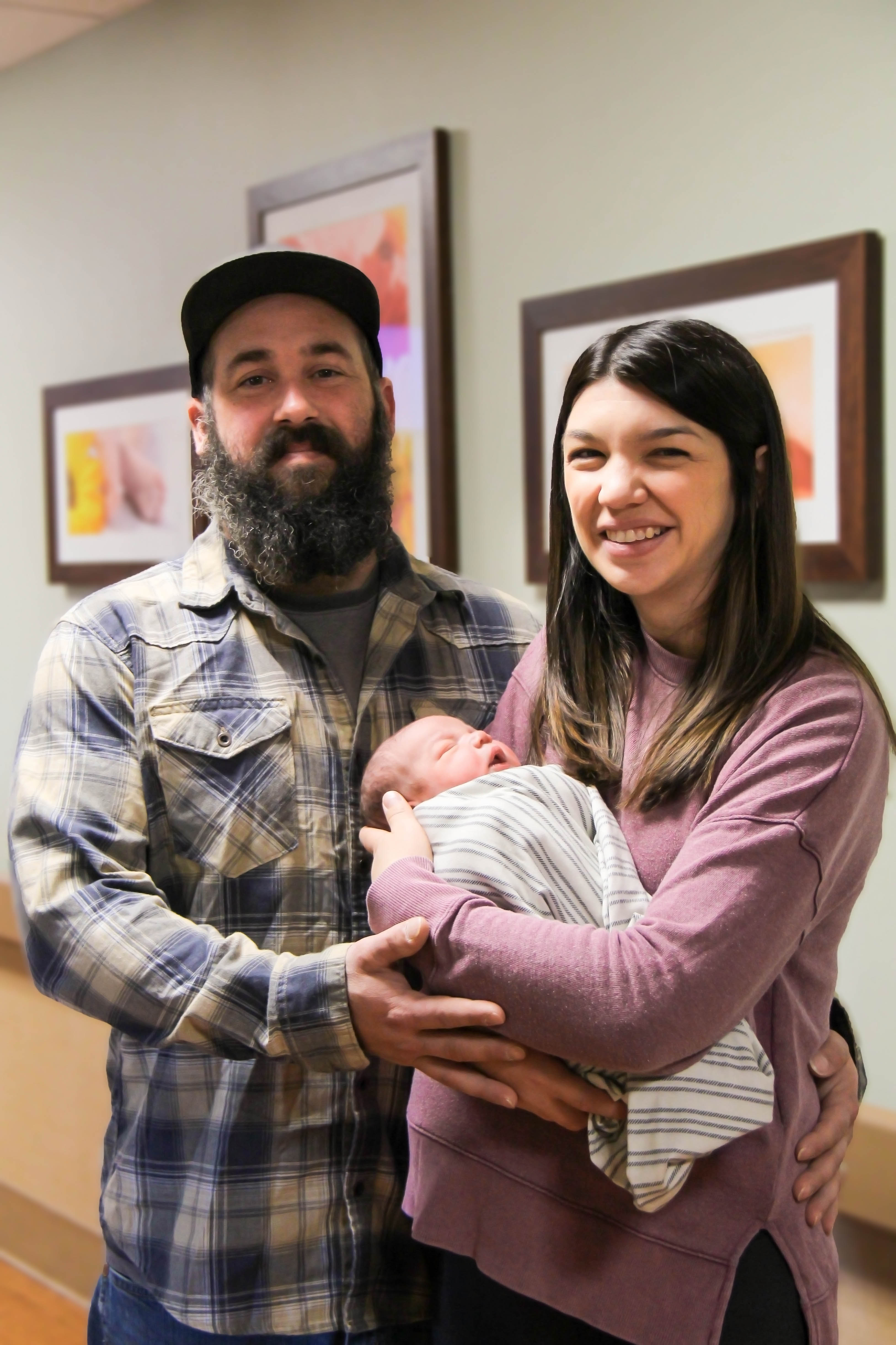 David and Nicole Taylor embrace son Mason, William Newton Hospital’s New Year’s Baby.
