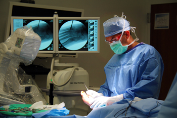 Podiatrist Thomas Lyman, DPM, of William Newton Foot and Ankle performs foot surgery in the H. L. Snyder Medical Foundation Surgery Center while using the new mini c-arm purchased by the hospital.