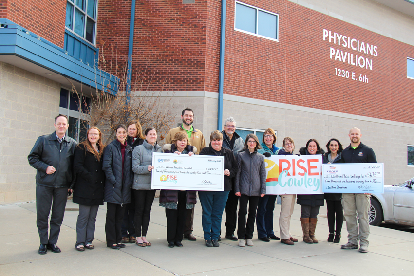 William Newton Hospital administration, William Newton Hospital employee wellness committee, RISE Cowley, and Conco Construction representatives gather at the Physicians Pavilion to commemorate the completion of the sidewalk project on the corner of 6th avenue and Cherry street. Front row from left: Ben Quinton, Tiffany Shinneman, Brandy Cuevas, Laura Frazier, Karen Adamson, Cheryl Brock, Ruth Bumgarner, Becky Reid, Sarah Werner, Sarah Johnson, and Paul Muckenthaler. Back row from left: Harlene Hoyt, Brian Barta, Thomas Langer, and Lorri Greenlee. NOTE: This photo was taken on February 27, 2020, prior to the state of Kansas executive order on public gatherings.