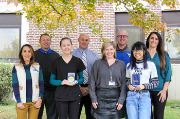 Winfield High School Health Science Careers students show off their ‘Scratch & Help’ booklets which will raise funds for William Newton Hospital and new scrubs to be worn during site rotations. Front row from left: Sarah Bryant, William Newton Hospital director of marketing, Addison Barg, William Newton Pediatrics shadow and Winfield Health Occupation Students of America vice president, Annika Morris, William Newton Healthcare Foundation director, and Donna Duong, Winfield Surgery and Services shadow and Winfield Health Occupation Students of America president. Back row from left: Eric Flaton, Winfield High School principal, Eric Cooper, Winfield High School assistant principal, John Kaufman, Winfield High School athletic director, and Danae Pfizenmaier, Winfield High School assistant principal.