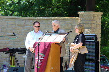 At center, Larry Hatteberg presents a framed assembly of William Newton Memorial School of Nursing memorabilia belonging to his mother, Evelyn, to hospital CEO Ben Quinton, left, and William Newton Healthcare Foundation Director Annika Morris, right.