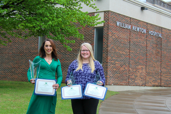 William Newton Hospital’s Sarah Bryant, left, and Kylie Stamper, right, display several awards earned for excellence in healthcare marketing, including Best in Show.