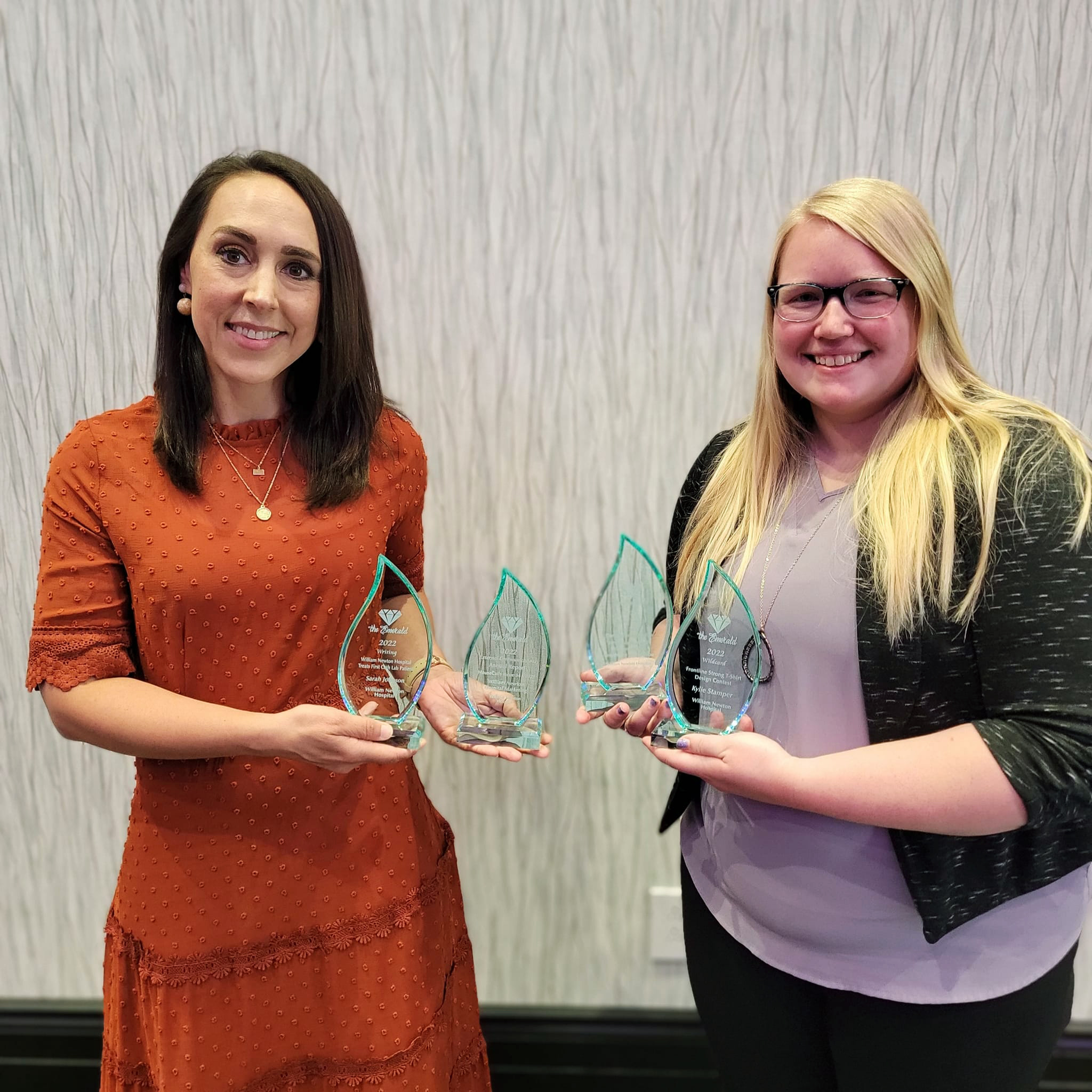 William Newton Hospital’s Sarah Johnson, left, and Kylie Stamper, right, display several awards earned for excellence in healthcare marketing and communications.