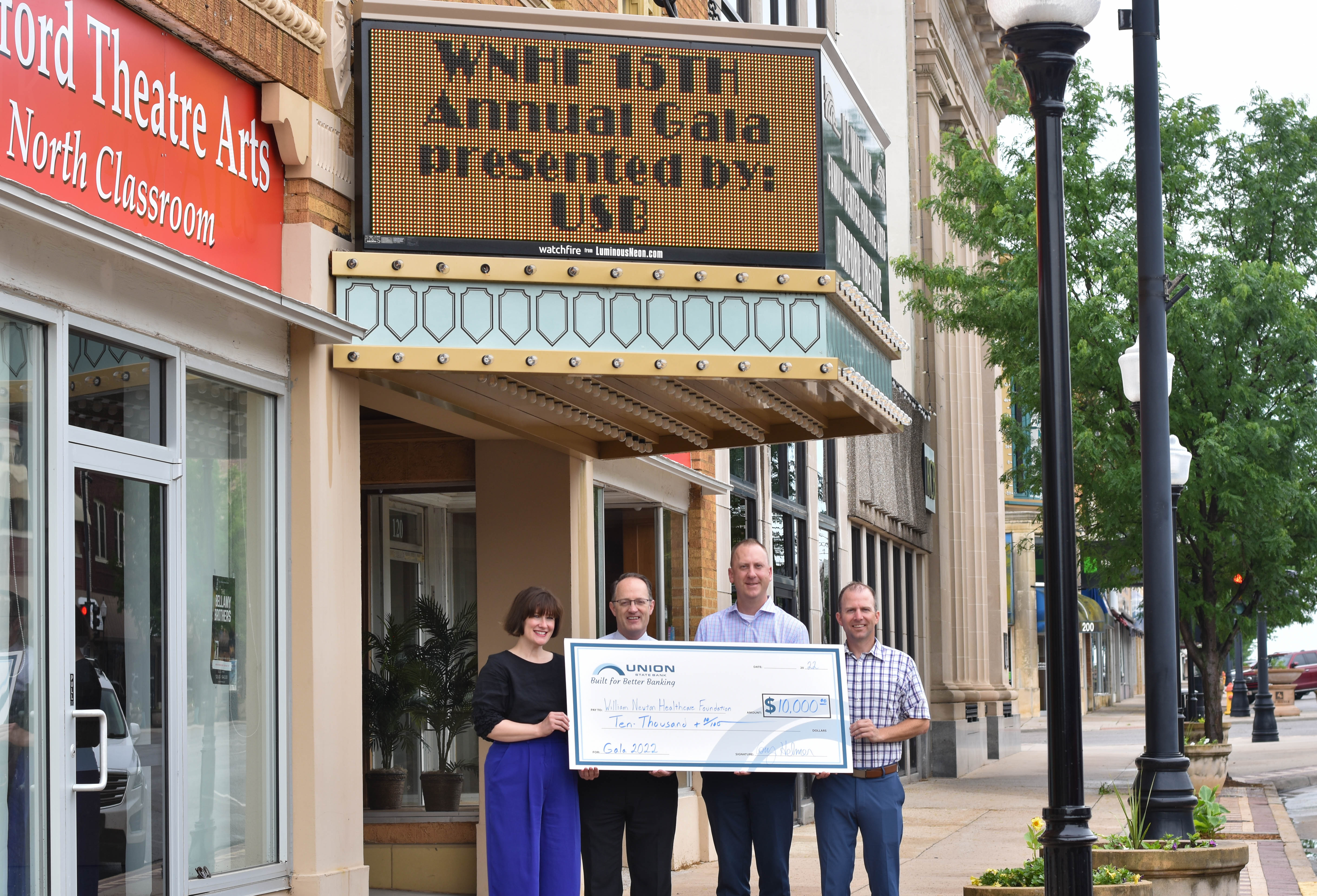 Standing in front of this year’s gala venue, the Burford Theatre, Union State Bank presents a check for the renewal of its annual sponsorship benefiting William Newton Healthcare Foundation. From left: William Newton Healthcare Foundation Director Annika Morris, William Newton Hospital Chief Executive Officer Ben Quinton, Union State Bank Winfield Market President Cory Helmer, and Union State Bank Vice President/Mortgage Lender Rusty Zimmerman.