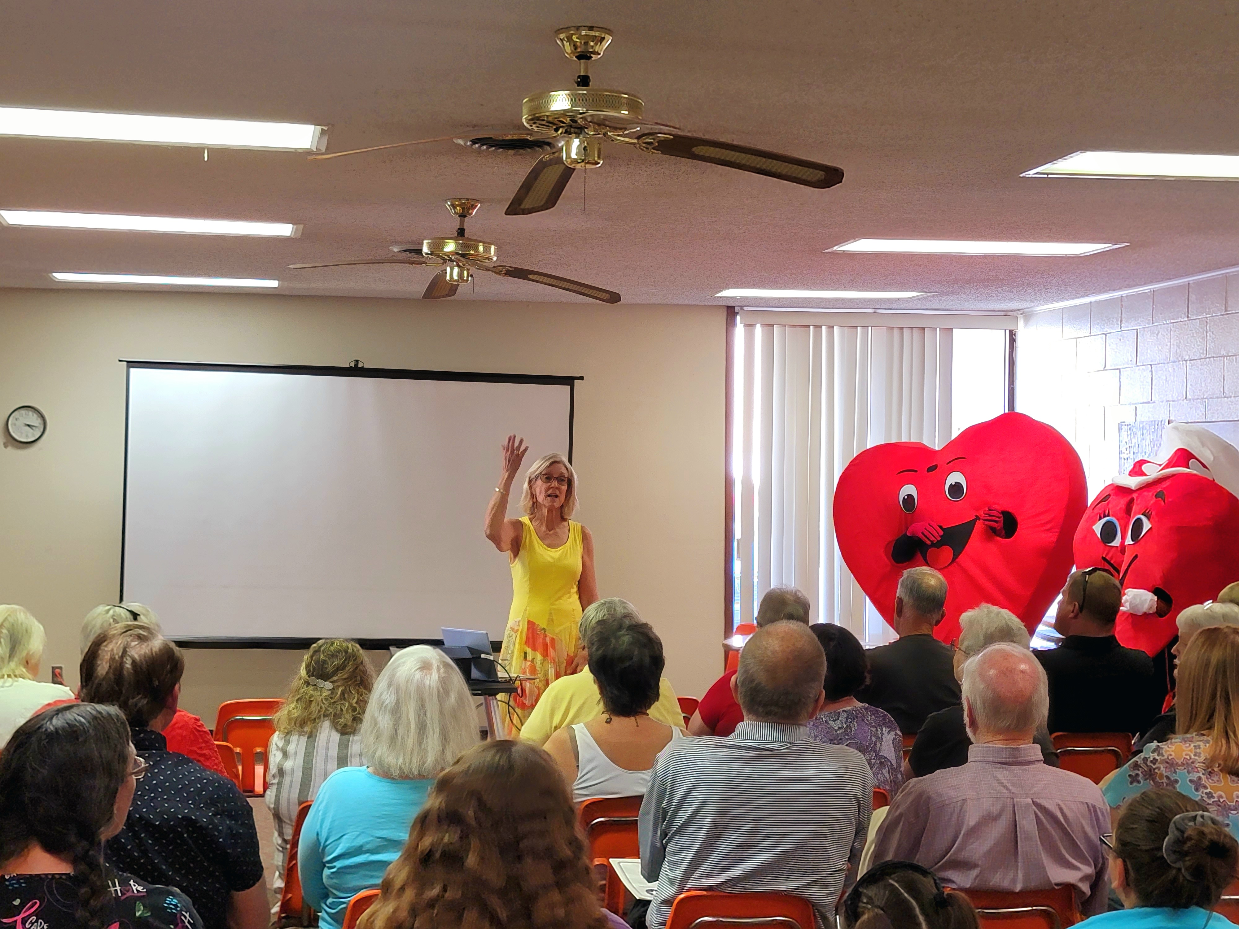 Willy and Mary Beat, mascots for the Beats Go On initiative, appear with nurse practitioner Shirley Black at the Moline Public Library.