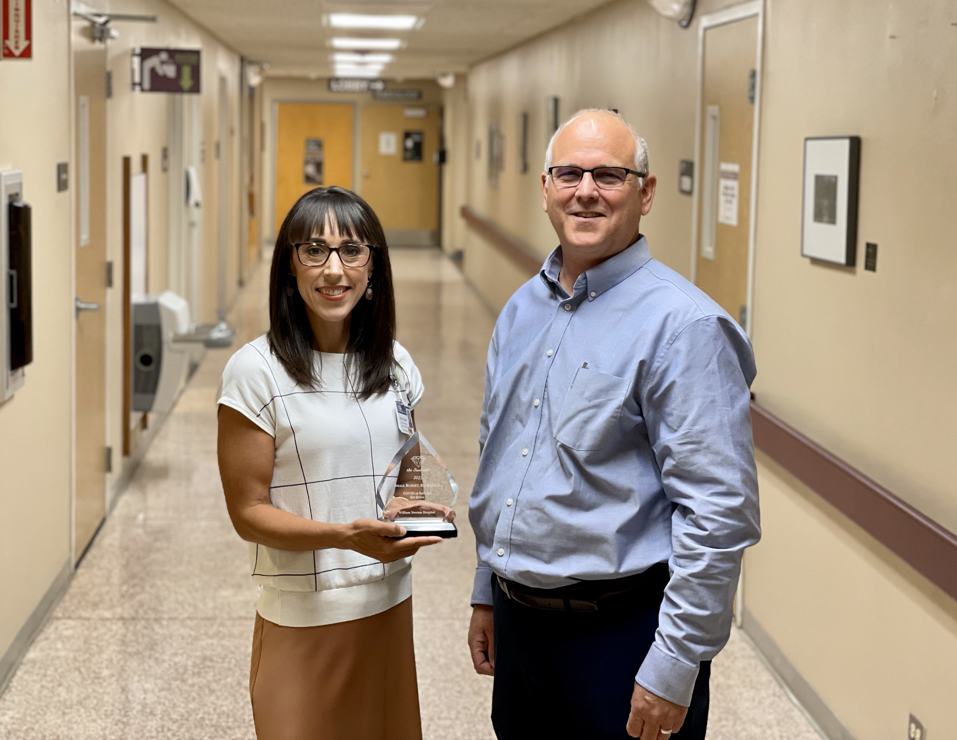 Johnson, left, and Community Health Center in Cowley County’s David Brazil receive an award for their work on the COVID-19 Self-Test Kit distribution event.