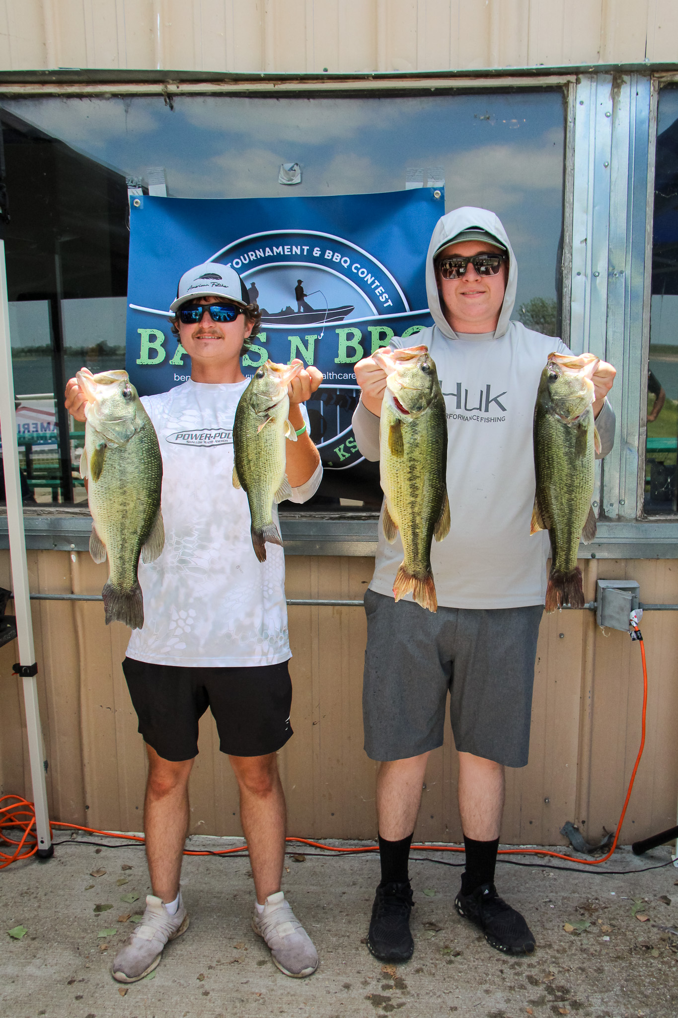At left, bass fishing tournament winner Koal Meier shows off his impressive catches alongside angler Timber Neal.