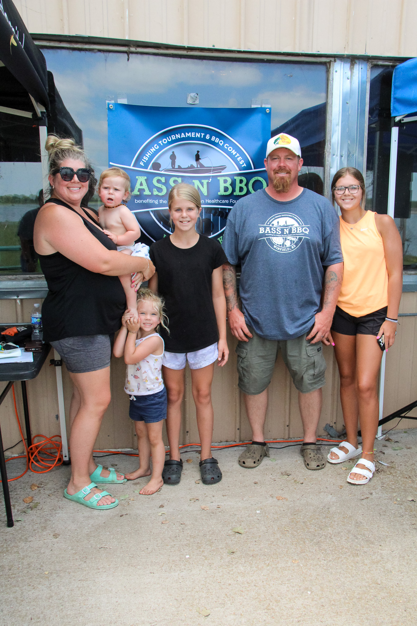 Barbeque competition winner Dustan Staten, second from right, poses with wife Jessicah, left, and their children after earning a $500 payout for his brisket.