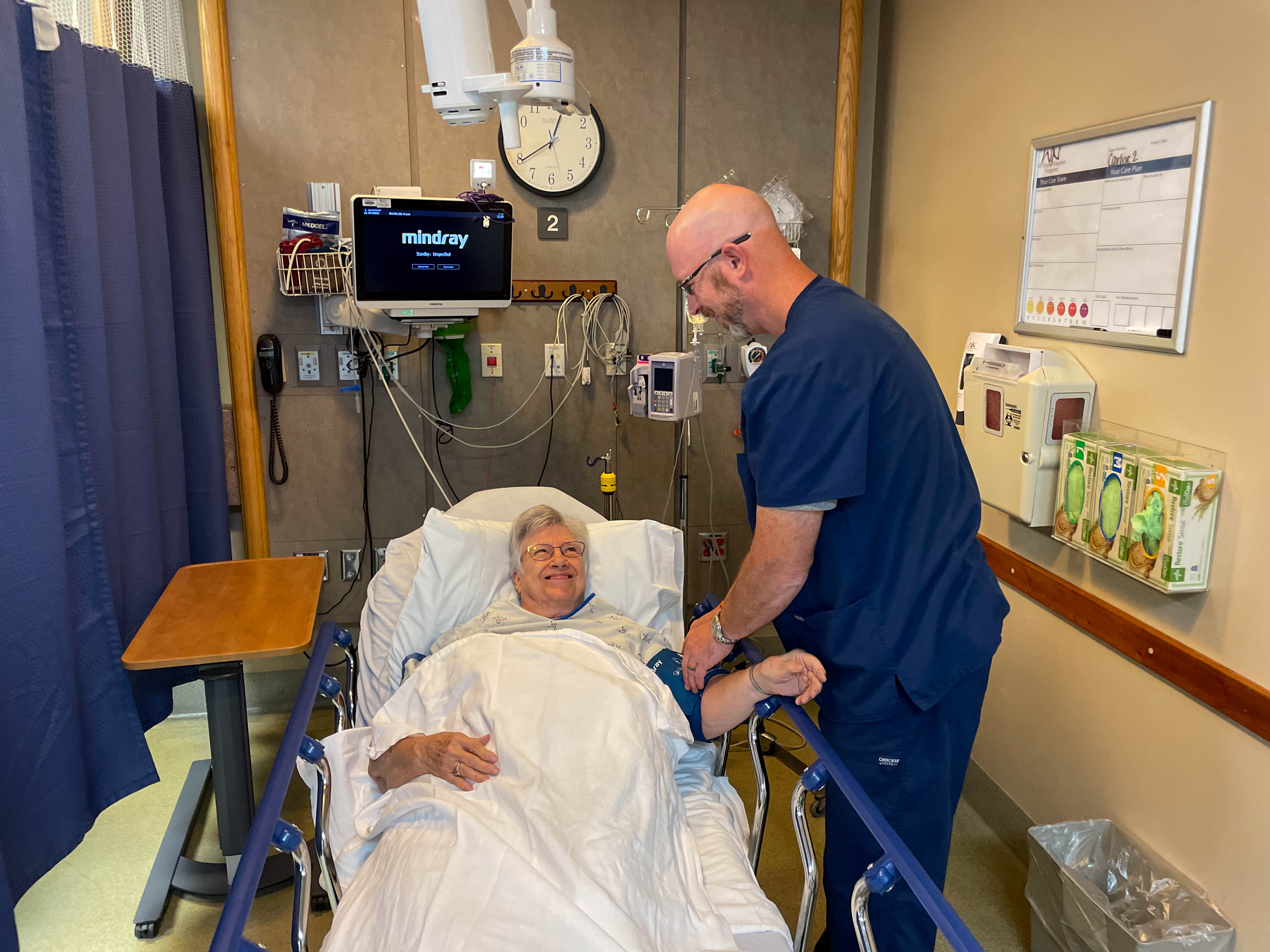 Nurse Steven Kramp helps a patient get comfortable in the William Newton Hospital emergency room.