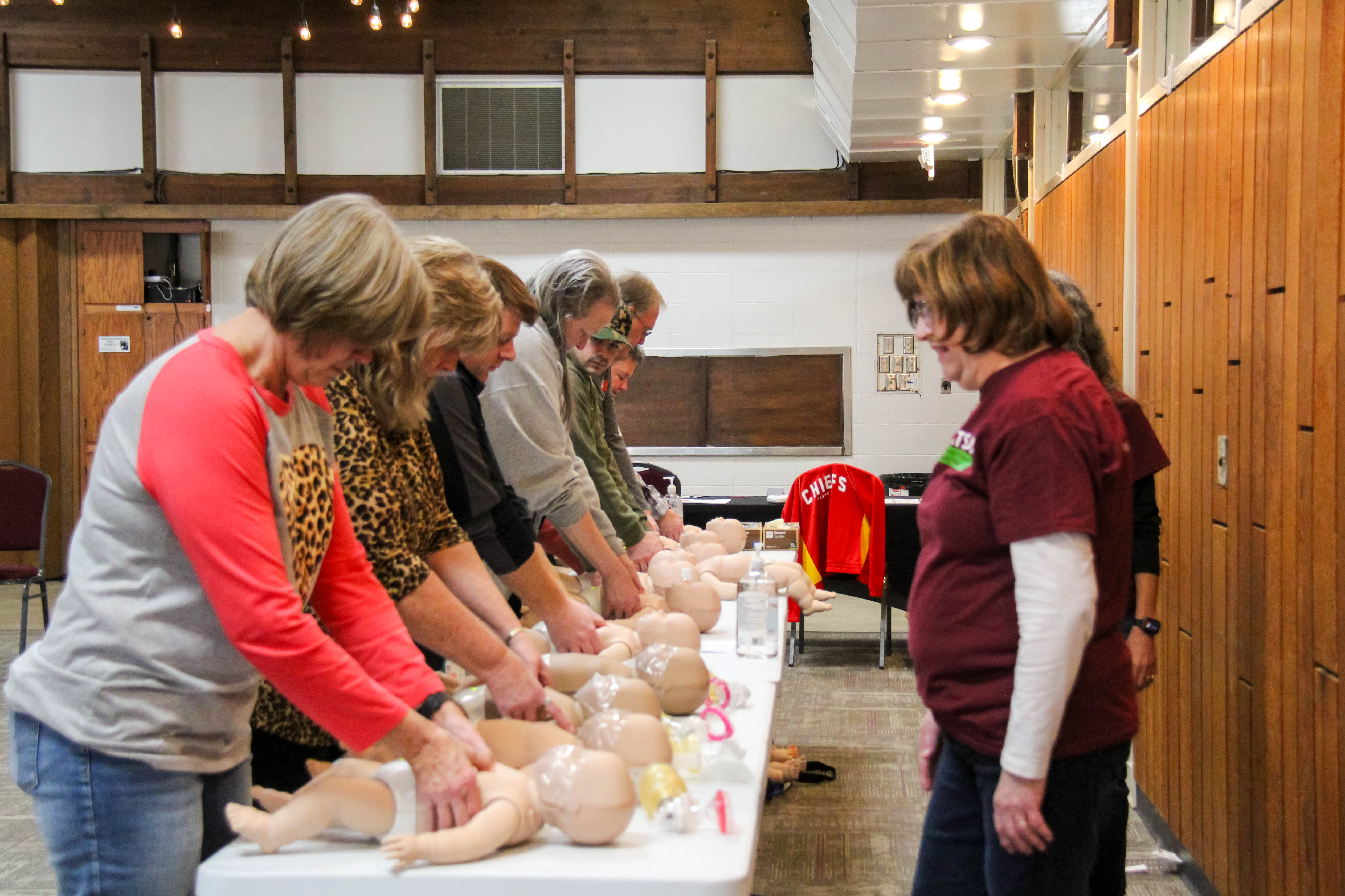 Over 100 professionals and community members were CPR certified in February at Baden Square as part of the Beats Go On community wellness initiative. At right, instructor Barb Humpert teaches infant CPR.