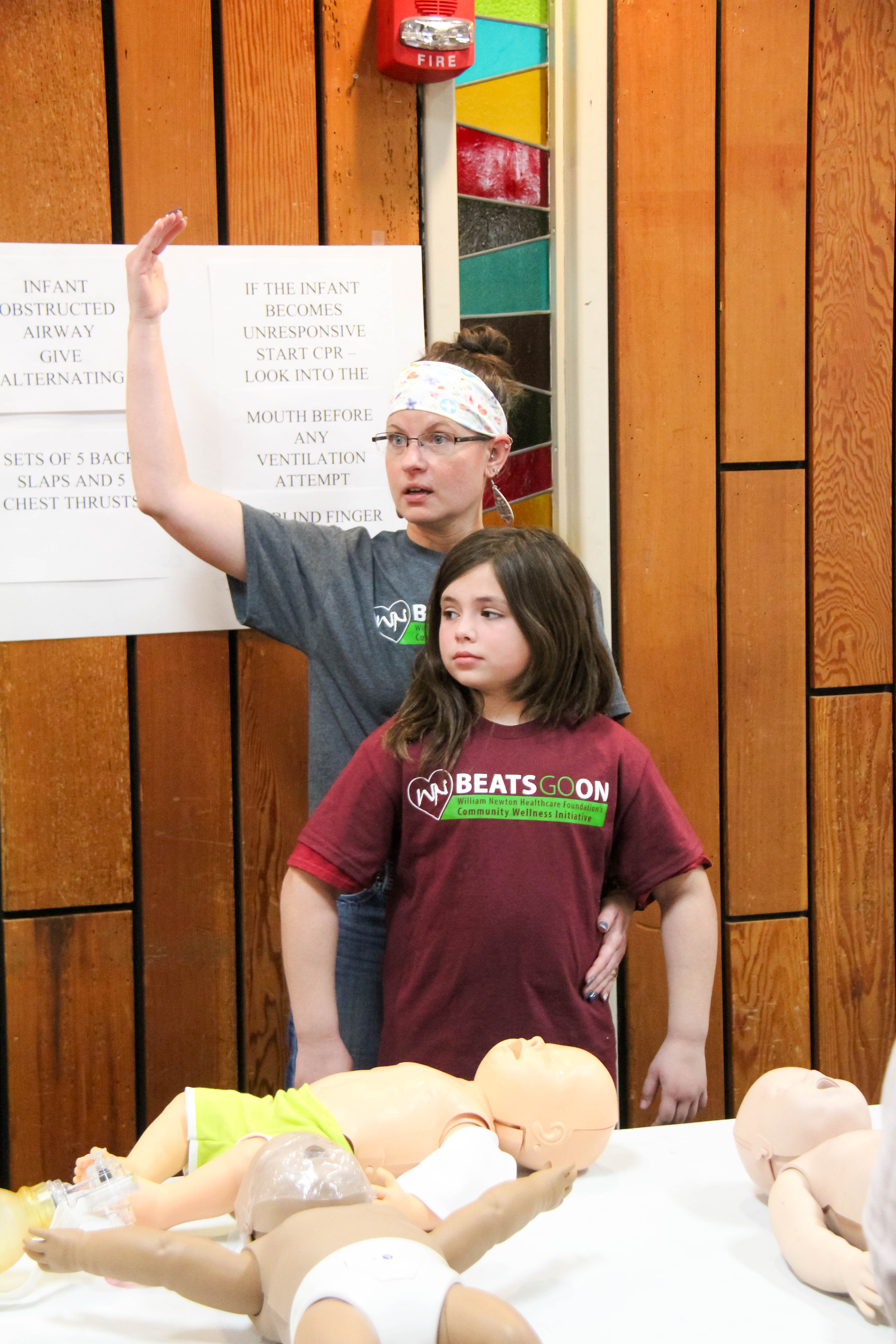 Nurse Sarah Owens, USD465, uses eight-year-old Darby Stein to demonstrate the Heimlich maneuver.