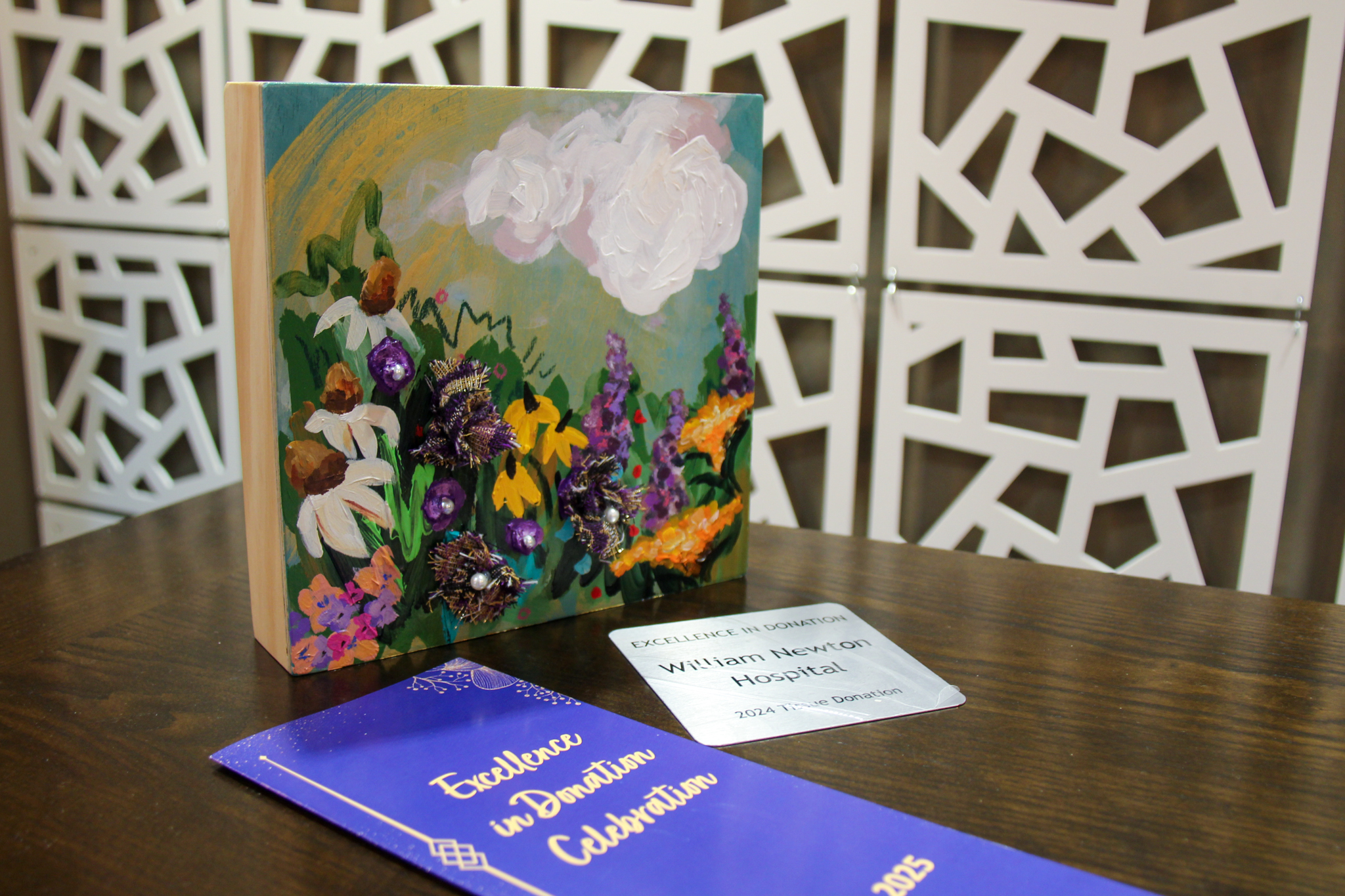As part of the 2025 Excellence in Tissue Donation Award, William Newton Hospital was presented with special artwork commissioned in honor of Gretchen Gosch, a beloved Midwest Transplant Network staff member and organ donor.